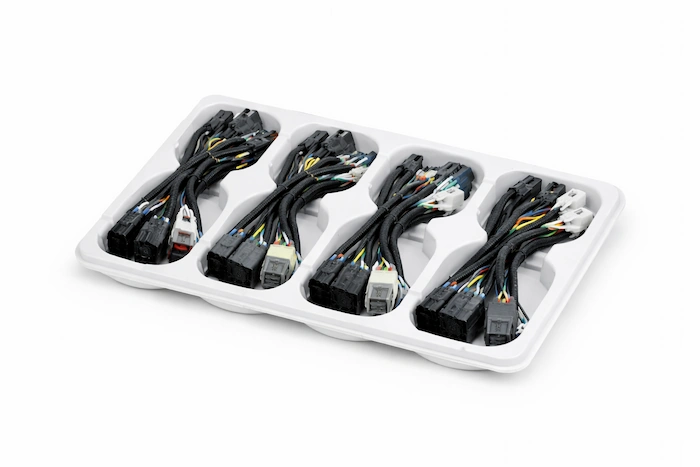 Thermoformed automotive tray for wire harnesses
